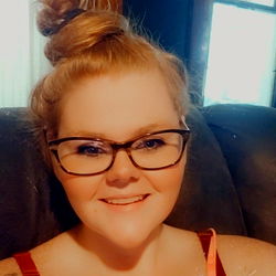 Smiling Woman in Glasses and Sweater