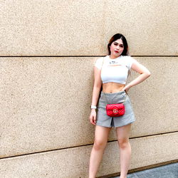 Model Yonna Desty posing for photograph on city street