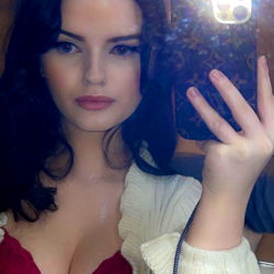 Stylish model in vibrant outfit posing for phone camera