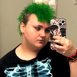 A Unique Style: A Model Posing with Vivid Hair and a Distinct Phone Case