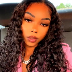 iPhone Screenshot of a Woman with Wavy Hair Taking a Selfie