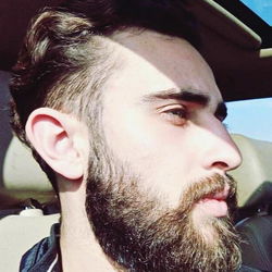 Bearded Man in Car with Window Reflection