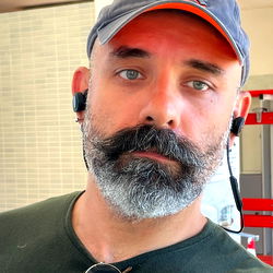 A Man with a Beard and Mustache, Wearing Headphones