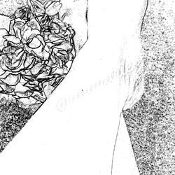 Black and white photo of a person's foot with flowers on top,