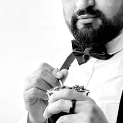 Barista enjoying a cup of coffee with his hands in a mixing bowl, ready to create an artful pour.