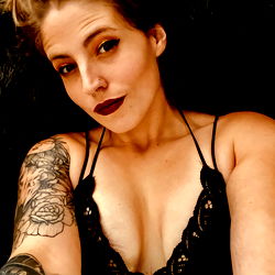 Casually Tattooed Woman with Sensual Expression on OnlyFans