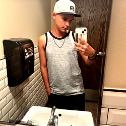 Andr3wx at a restroom mirror with phone