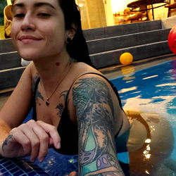 Tattooed woman in pool
