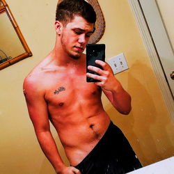 Muscular Man in Bathroom Mirror