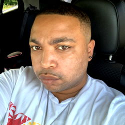 Shawn from the United States, in a casual setting with his car door closed.