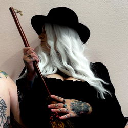 Stylish Model with Tattoos in a Theatrical Pose