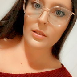 A person with glasses and a red top