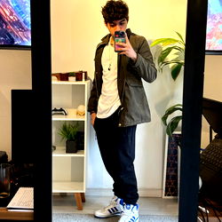 A Young Brazilian Male Model Standing in a Room