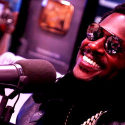 AB in a Radio Studio, Smiling and Holding Microphone