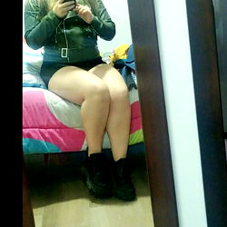 Stylish and Elegant Female Model in a Leather Jacket with Shorts