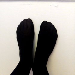 A.E.R's Bare Feet Against Wall