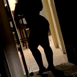 An OnlyFans Model Standing in a Doorway at Night