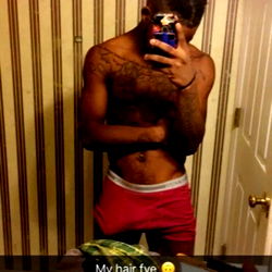 Person in bathroom mirror holding phone