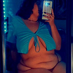 Full-figured woman in a blue bikini, showcasing her curves.