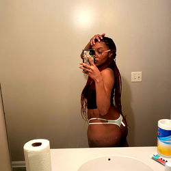 SexcMae, a lingerie model posing in the bathroom