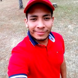 Young Man in Red Polo Shirt, Taking a Selfie Outdoors