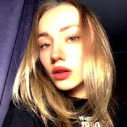 Anna Lysenko's Thoughtful Portrait with Purple Curtain Background