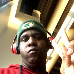 Man in Green Beanie and Headphones