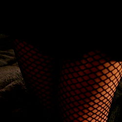 Alluring Model Showcasing Garter and Fishnet Stockings