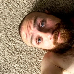 A Shirtless Man Relaxing on the Floor
