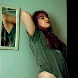 Ananda, OnlyFans Model, Resting Her Arm on the Wall