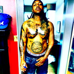 Confident Rapper in Tattooed Muscle