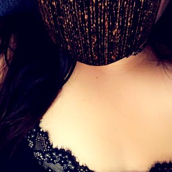 Woman in Lingerie with Mask and Gold Sequin Background