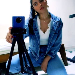 Stylish AnaRiver, a Colombian model posing with professional camera equipment.