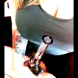 AhnyaBird: A Female Adult Content Creator Showcasing Her Tattoos and Vape Pen
