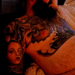 Inked Man in Tattoo-Themed Room