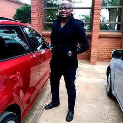 Modern Vehicle with a Black Suit Man in Parking Lot