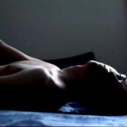 Intimate Moment of a Model Resting on Bed