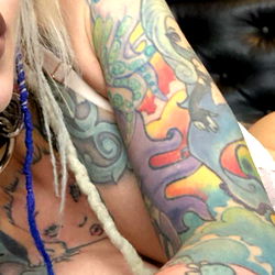 Detroit-Based Alloy Ash, a Tattooed Model Posing for the Camera
