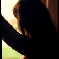 Woman in Window with Long Hair, Blurred Background