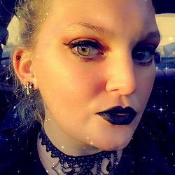 Stylish Female Model with Dark Lipstick and Earrings