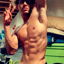 Fitness enthusiast strikes pose in home gym