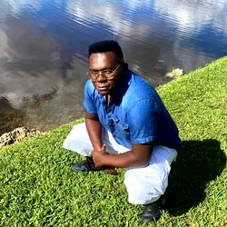 AJ in a casual pose on the riverbank