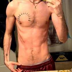 Muscular Young Man Showcasing his Tattoo and Physique