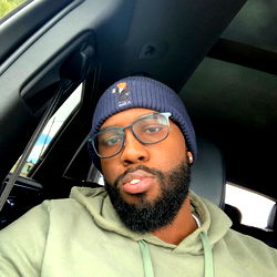 A man in a car, posing for a photo