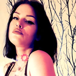 Rosa, a striking model with bold makeup and tattoos