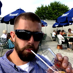 Man enjoying a drink at an outdoor cafe