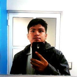 Man's Portrait in a Mirror with Black Leather Jacket and Phone