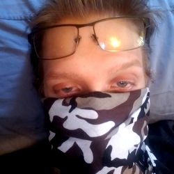 A Young Man with a Camouflage Mask and Glasses