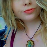 Young woman with blue eyes and a green necklace