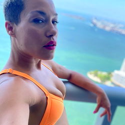 FoxyB on a balcony with ocean view